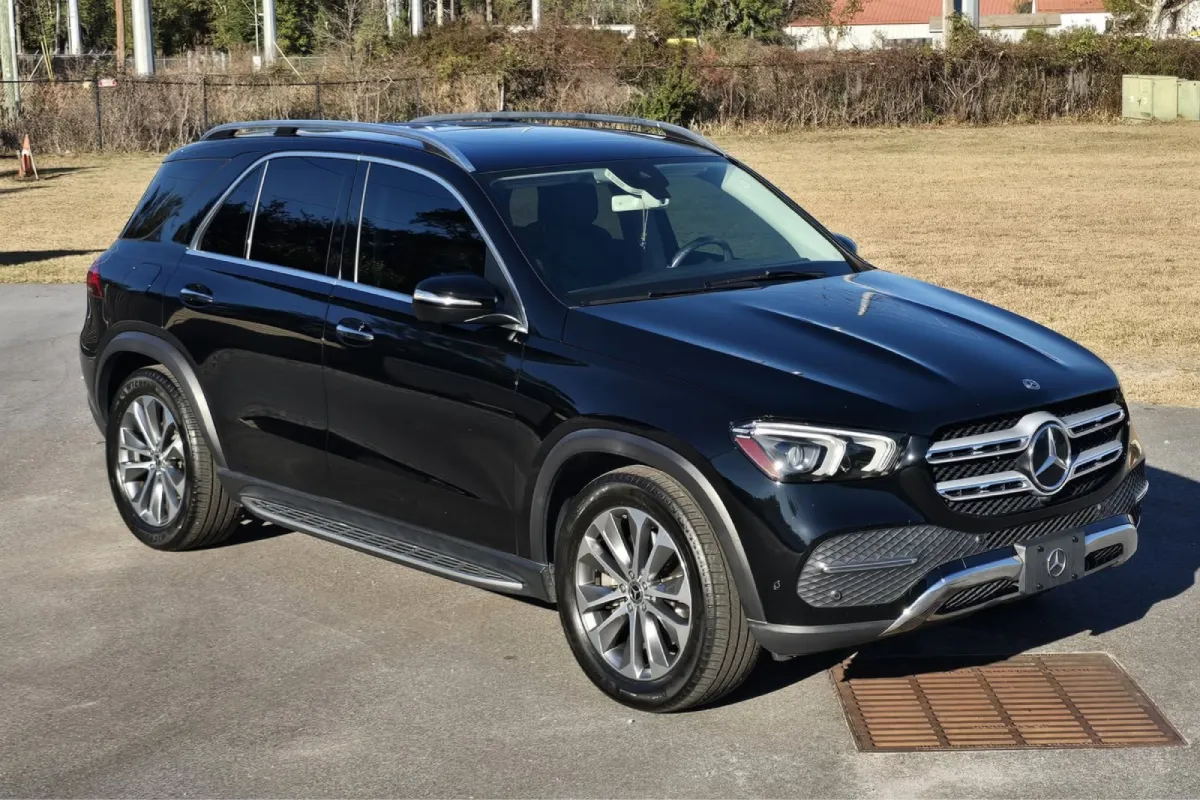 Front angle of black car in sunlight with clean polished exterior