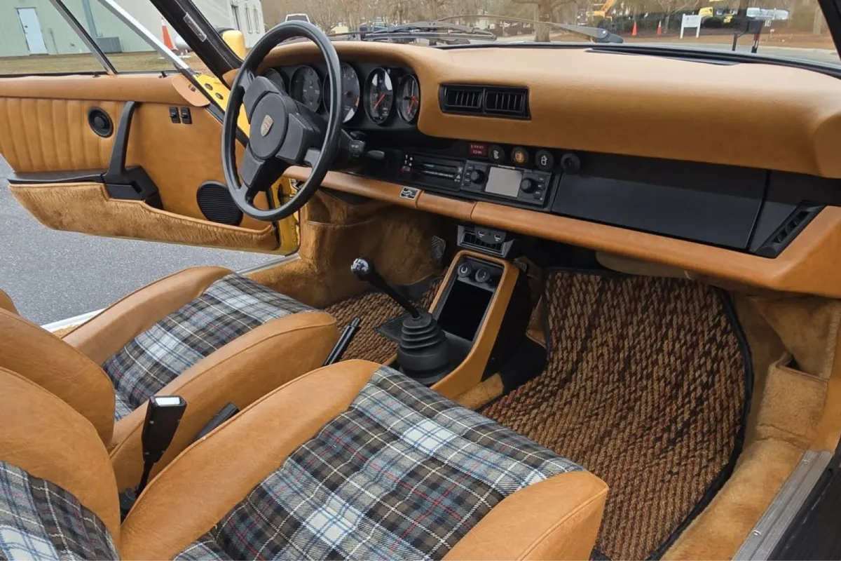 Interior view of yellow car with leather and plaid seats