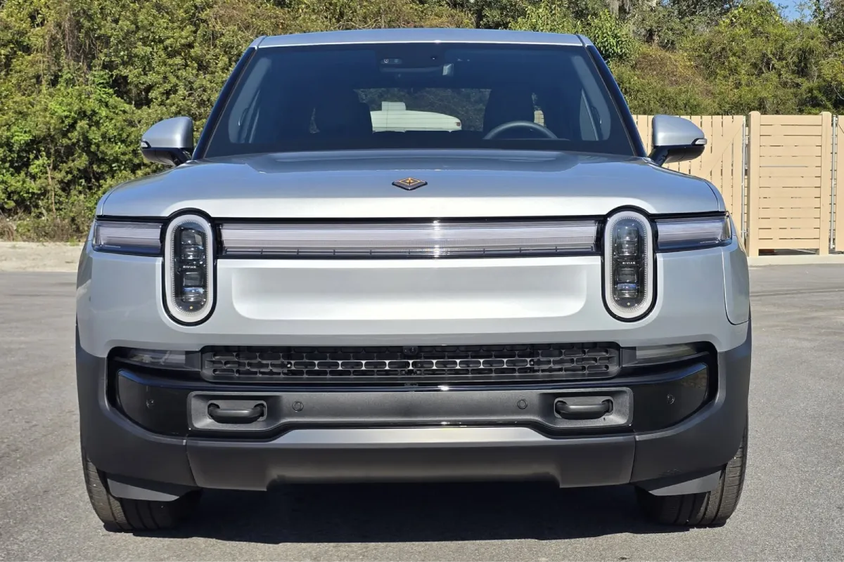 Silver Rivian truck with paint protection film on the front end.