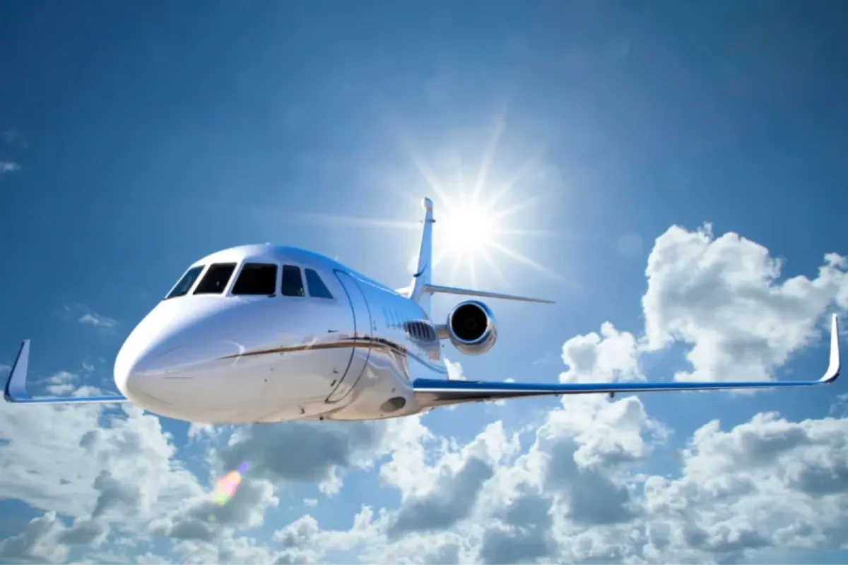 Private jet in flight with a polished exterior for aviation detailing.