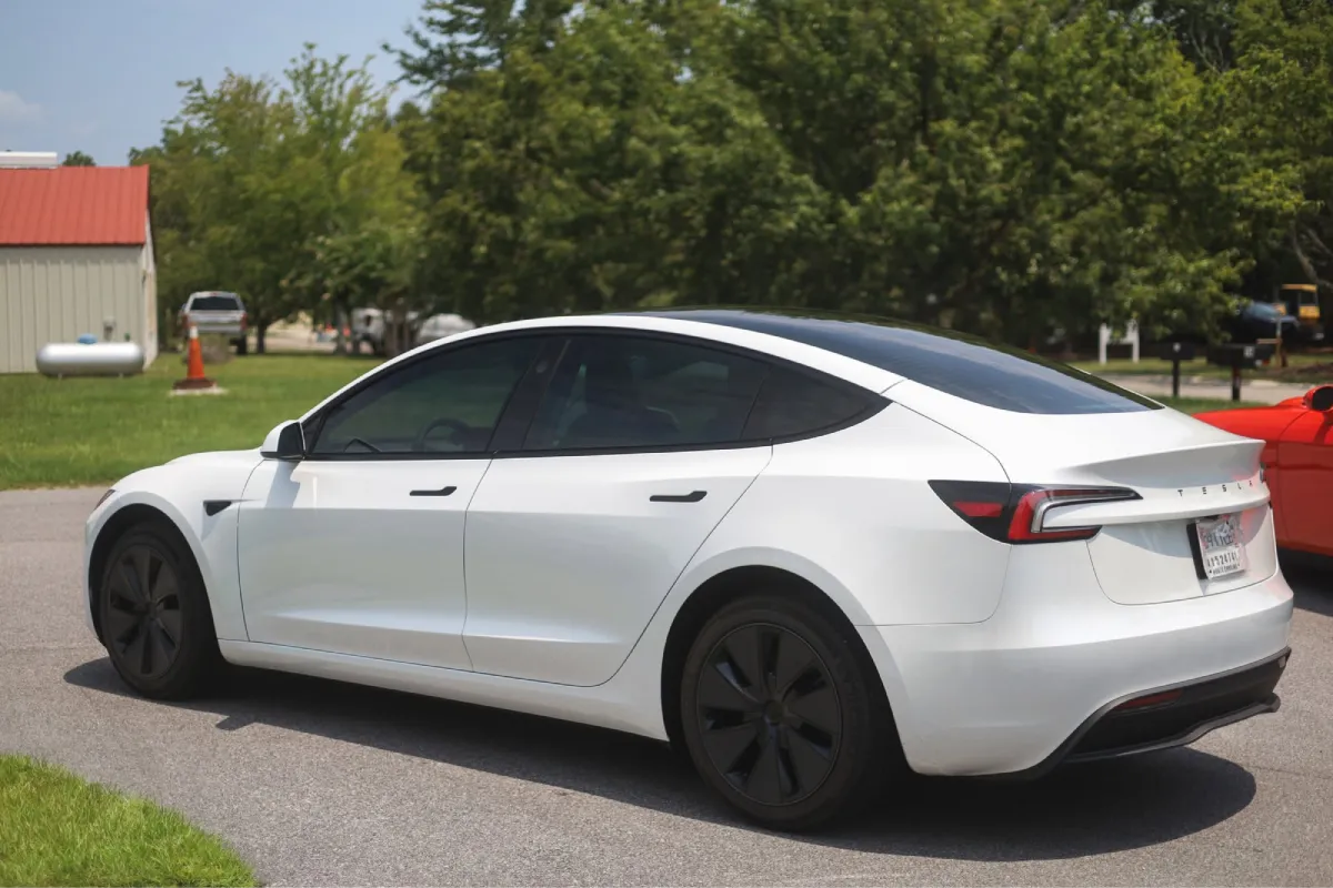 White Tesla Model 3 showcasing dark window tint.
